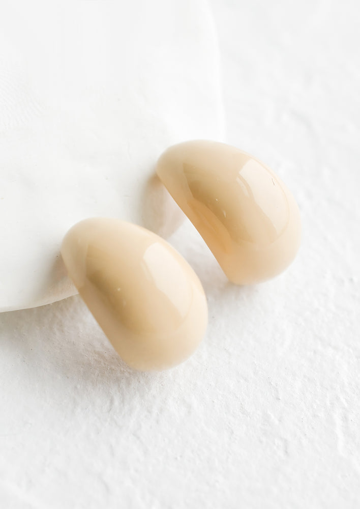 White Chocolate: A pair of glossy ivory bean shaped earrings.