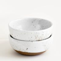 Glossy White / Soup: Two stacked white ceramic bowls with brown speckles.