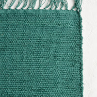 Aegean: A textured cotton rug in bottle green.