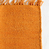 Goldenrod: A textured cotton rug in orange rust.