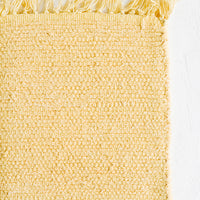 Maize: A textured cotton rug in light yellow.
