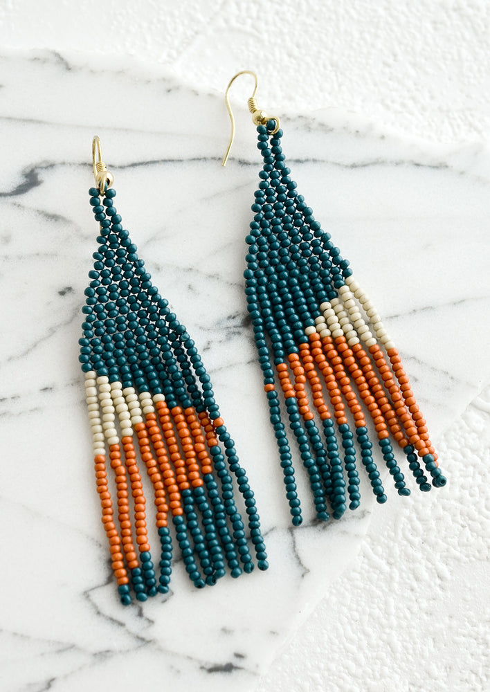 Dark Teal / Terracotta Multi: A pair of colorblocked beaded earrings with geometric design.
