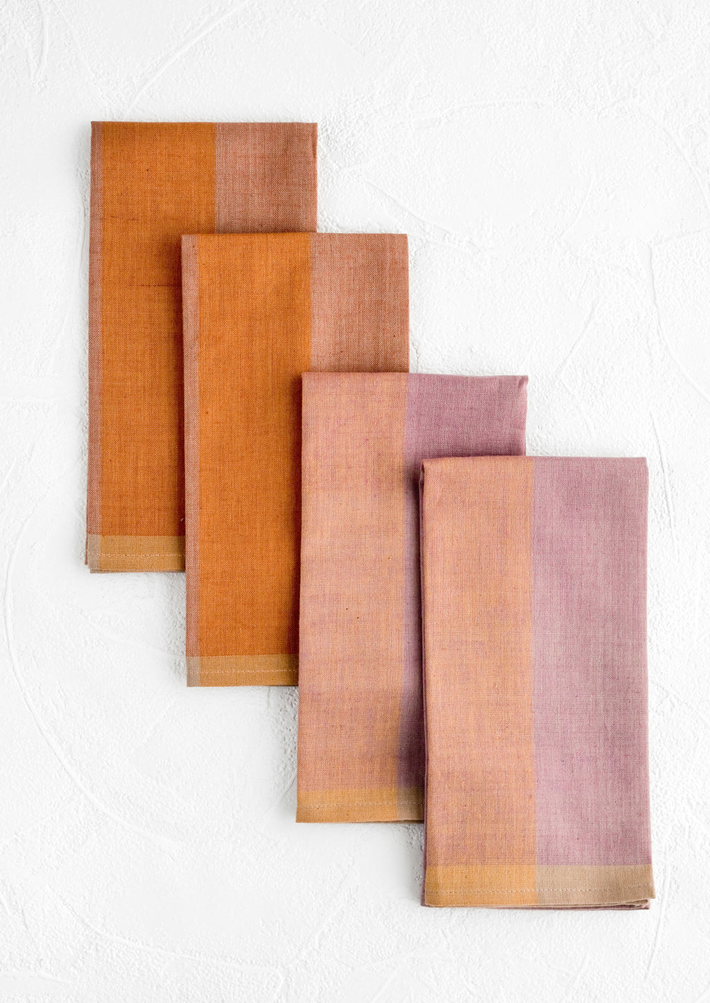 Jam Multi: Four fabric napkins in purple and orange colorblock design.