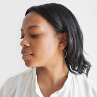 2: Model wearing colored crystal hoop earrings