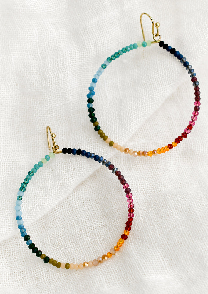 Rainbow Multi: A pair of beaded hoop earrings in gradient rainbow colors.