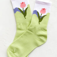 Lime Green: A pair of socks in lime green with pink tulip design at ankle.