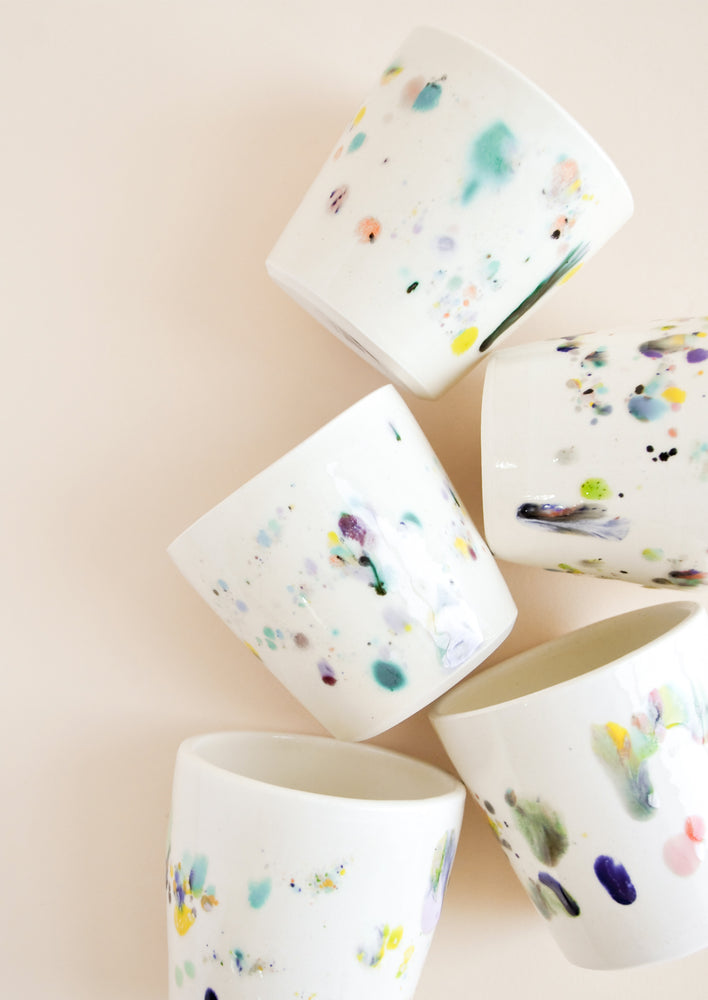 Small, one of a kind ceramic tumblers in ivory with colorful drips