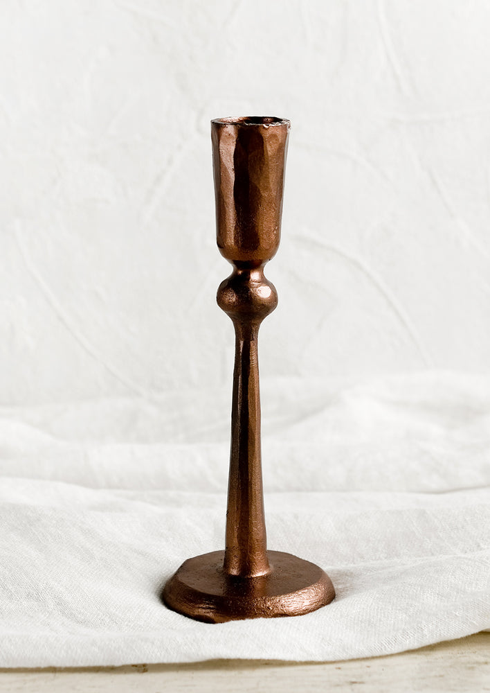 1: A copper candlestick holder in metal.