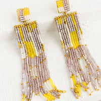 Yellow Multi: A pair of long beaded earrings in metallic mauve, white and yellow.