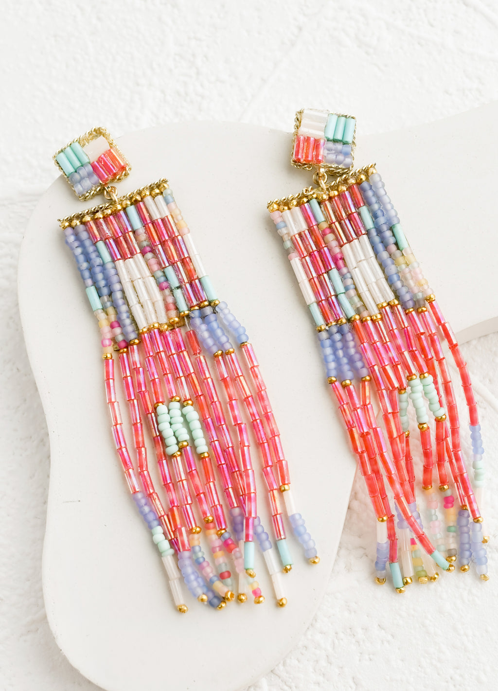 Pink Multi: A pair of long beaded earrings in metallic pink, lilac, white and aqua.