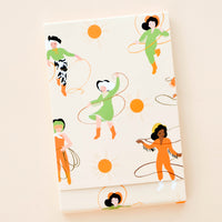 1: Covered notebook with playfully illustrated cowgirl & lasso print in green and orange
