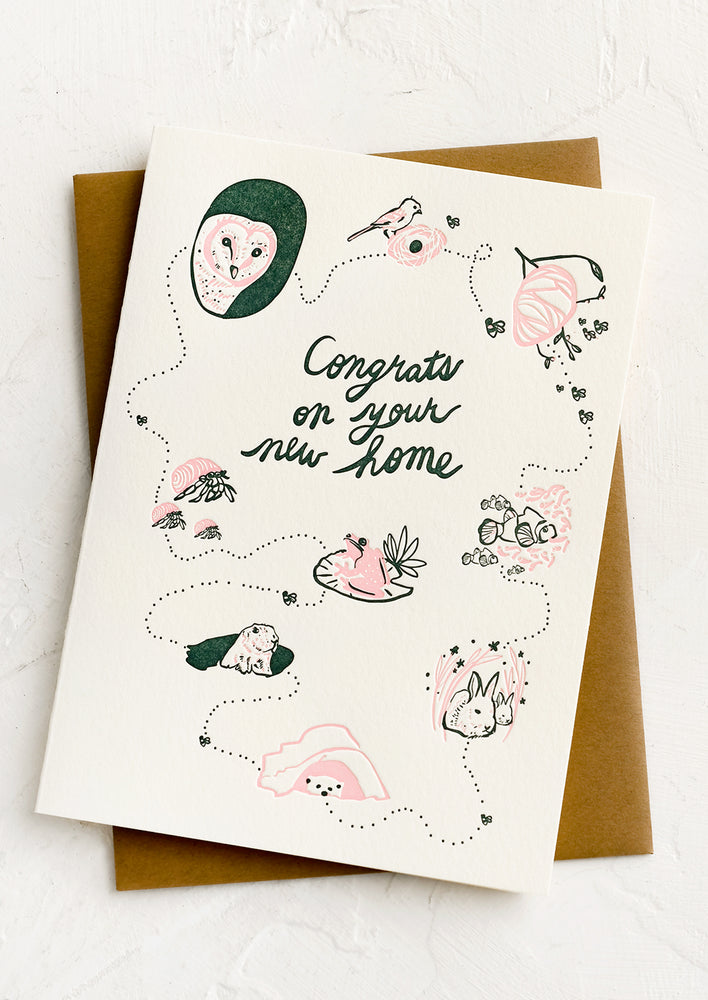 1: A card with drawings of animals, text reading "Congrats on your new home".