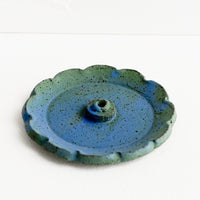 Borealis: A flower shaped ceramic incense holder in blue/green glaze.