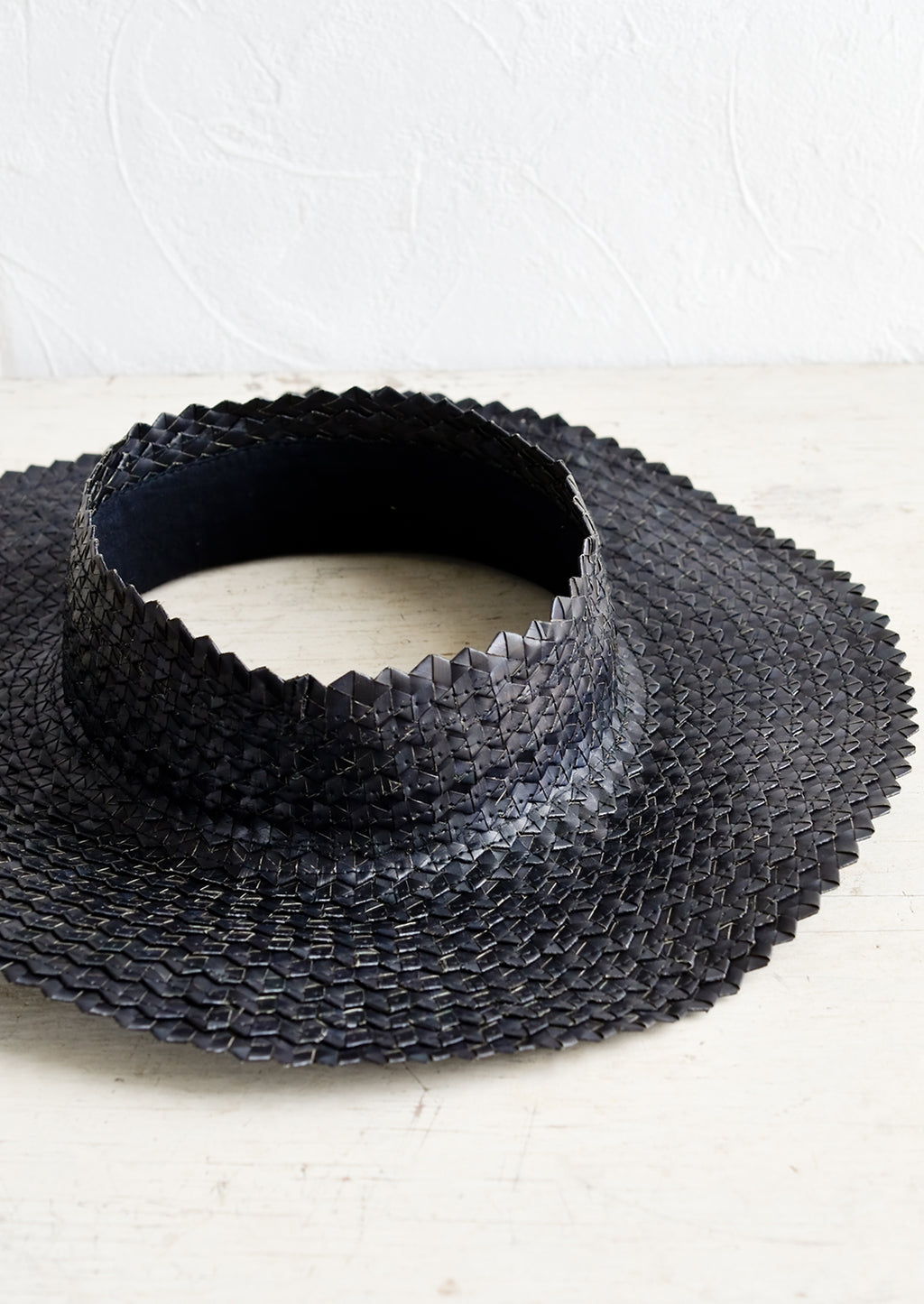 Black: A crownless straw sun hat in black.