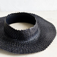 Black: A crownless straw sun hat in black.