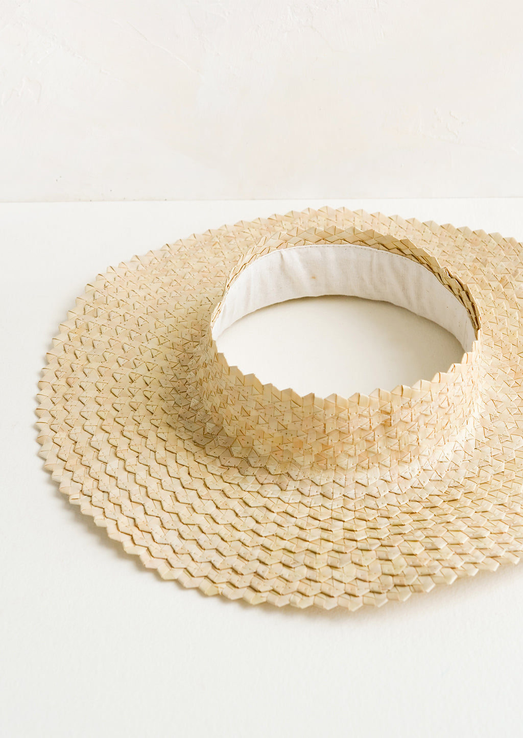 Natural: A crownless straw sun hat in natural.