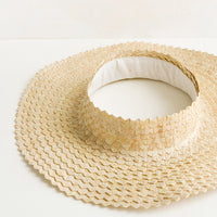 Natural: A crownless straw sun hat in natural.