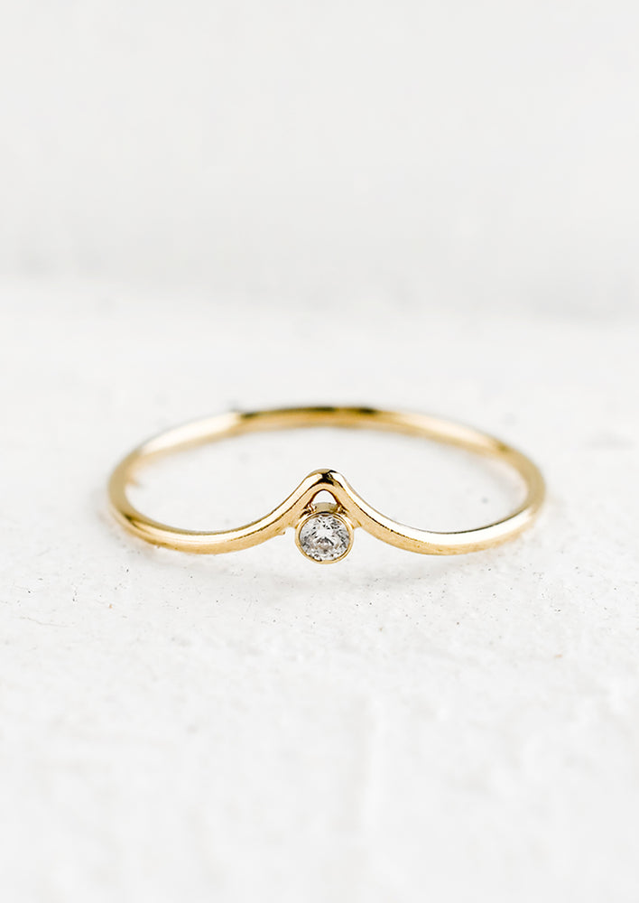 1: A gold ring with pointed center and single crystal bezel.
