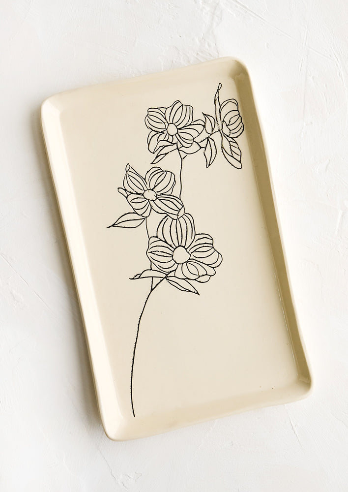 Dogwood: A rectangular ceramic tray in natural bisque color with an etched black drawing of dogwood flower.