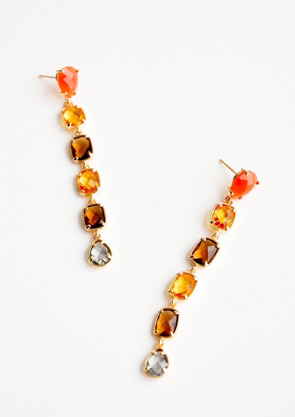 1: Post back drop earrings with six glass crystals of orange, yellow, amber, and blue.