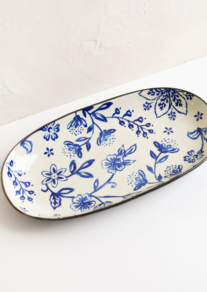 1: An oval shaped ceramic tray with indigo floral pattern on white background.