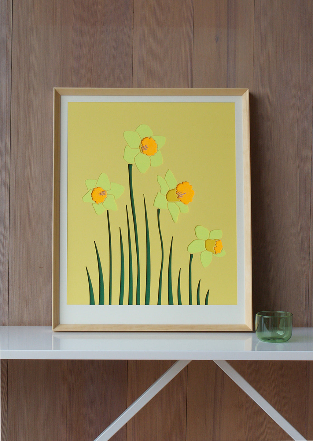 2: A lasercut artwork depicting daffodils on yellow background.
