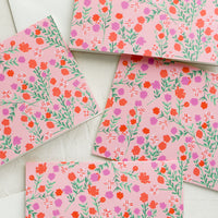 1: A set of pink cards with floral pattern.