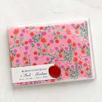 2: A set of pink cards with floral pattern in wax sealed packaging.