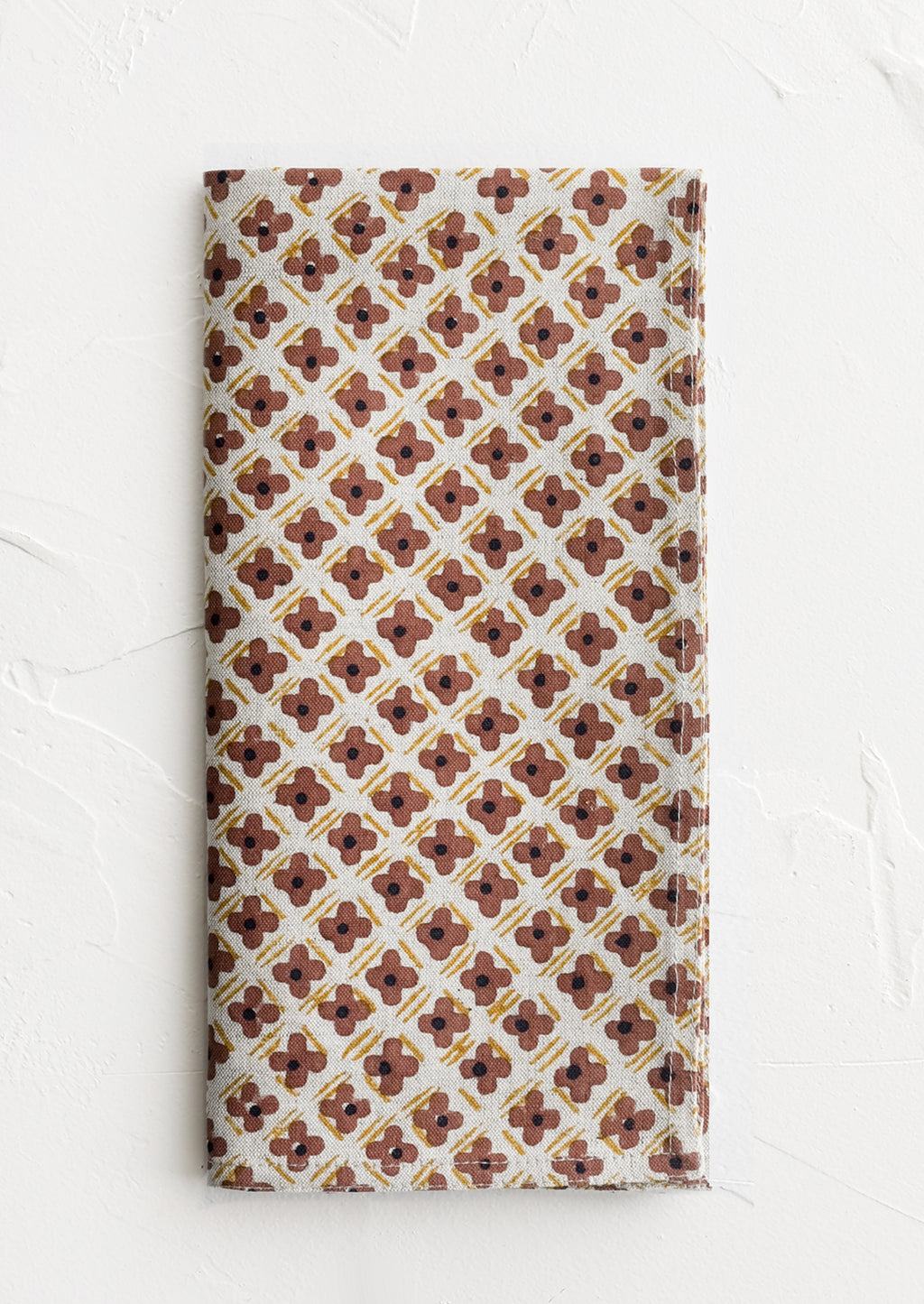 Clay Multi: A block printed napkin with clay and yellow floral print.