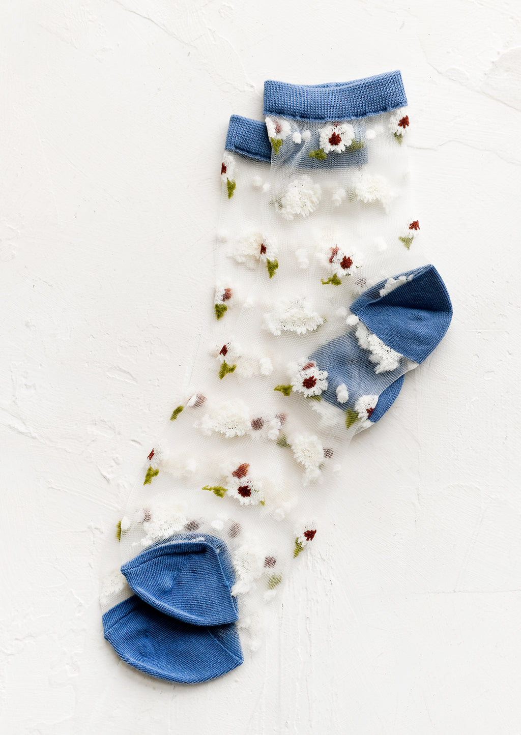Storm Blue: Sheer ankle socks with floral print and blue trim.