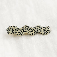 Dalmatian: A wavy hair barrette in black and white spot print.