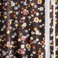 3: A floral print scarf with brown background and yellow and lilac border.