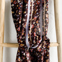 1: A floral print scarf with brown background and yellow and lilac border.