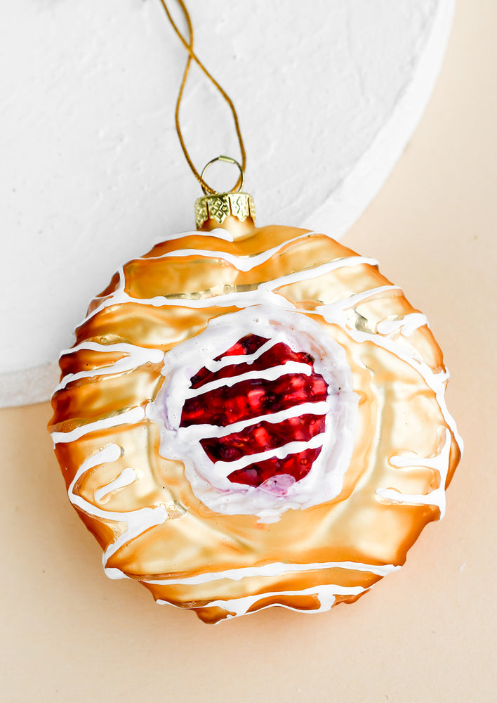 A holiday ornament of a cherry danish.