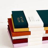 9: Stack of colorful cloth-cover notebooks