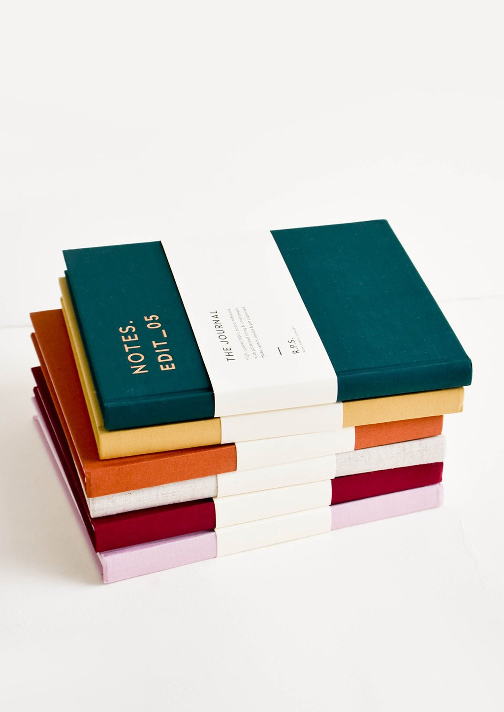 1: Stack of colorful cloth-cover notebooks