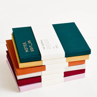 1: Stack of colorful cloth-cover notebooks