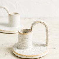 1: Ceramic taper holders with curved handle in speckled natural glaze.