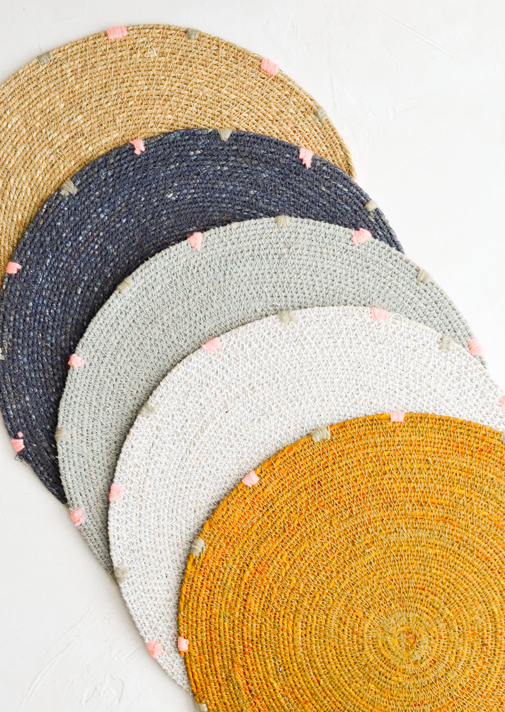 7: Five round seagrass placemats in assorted colors.