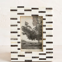 1: A tabletop picture frame in black and white dashes pattern.