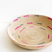 1: Woven platter made from date palm with pink and green design