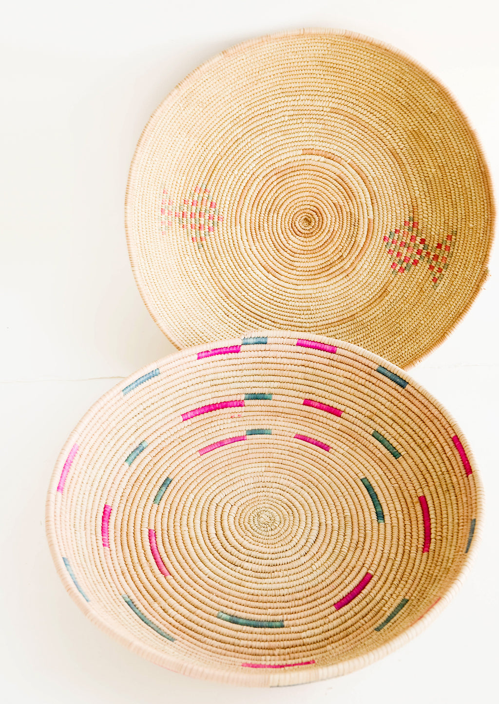 3: Round, woven platter made from date palm with pink and green design