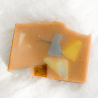 Terrazzo Grapefruit Mint: A peach colored bar of soap with multicolor terrazzo pattern.