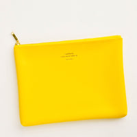 Yellow / Medium: Medium vinyl pouch with gold zipper and crosshatch texture, in bright yellow.