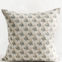 1: A natural linen throw pillow with floral block print pattern.