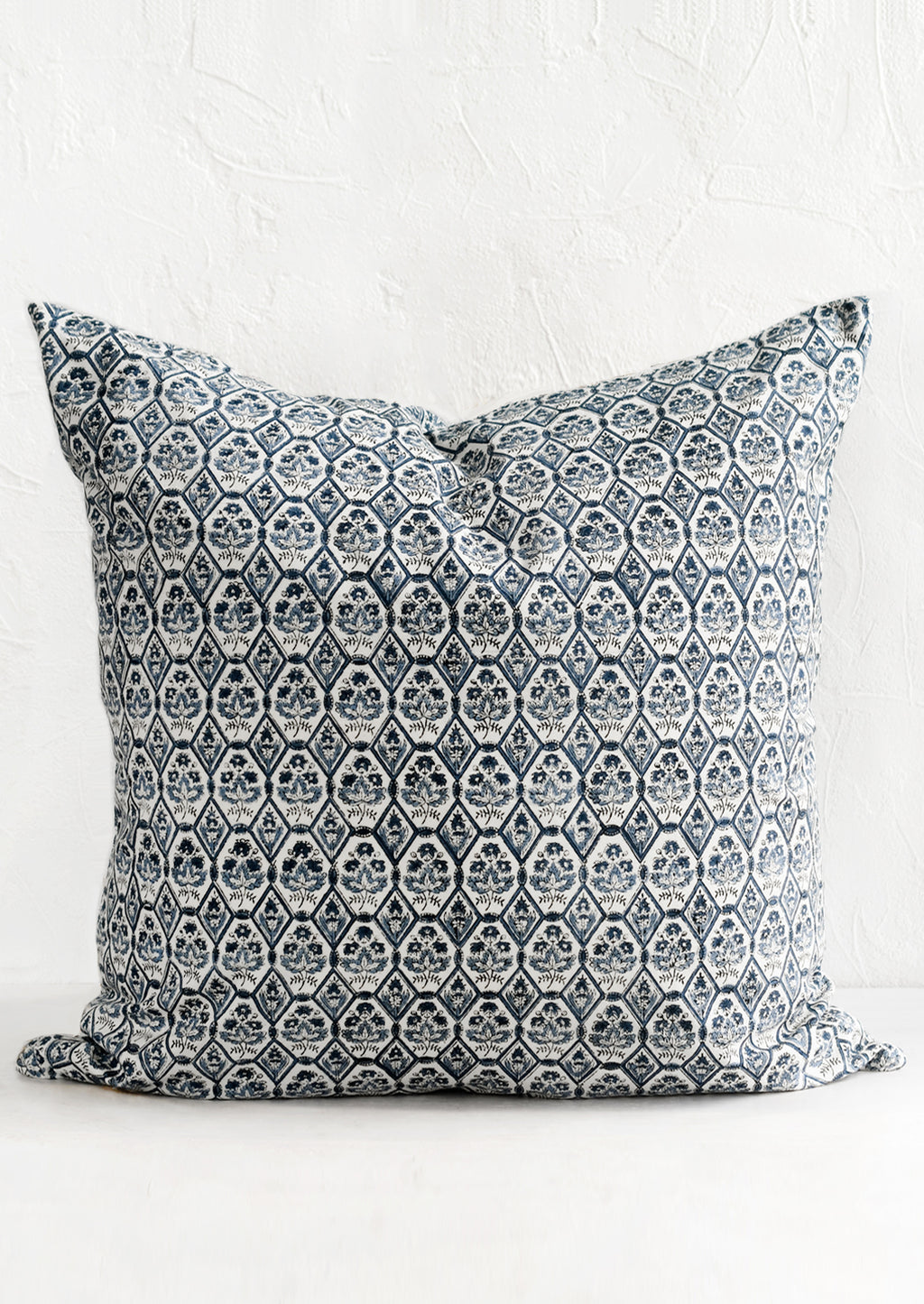 1: A block printed pillow in blue and white tile print.