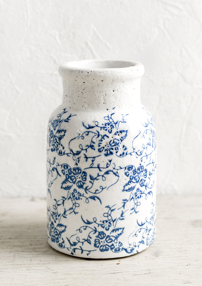 1: A blue and white ceramic vase with antique floral print.