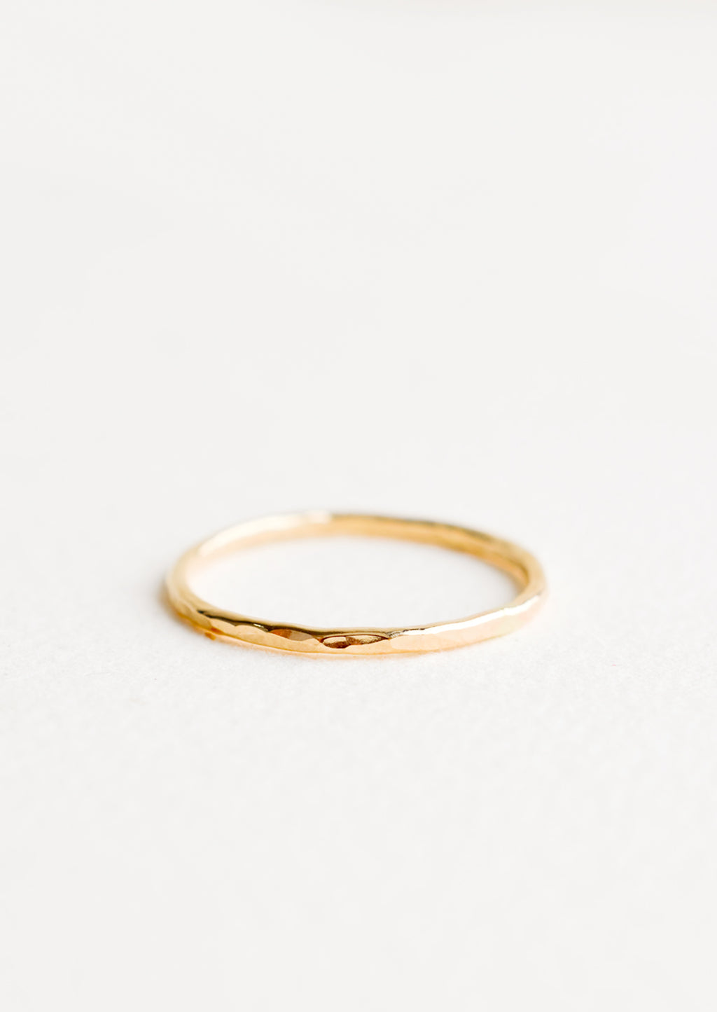 1: Thin hammered gold ring. 