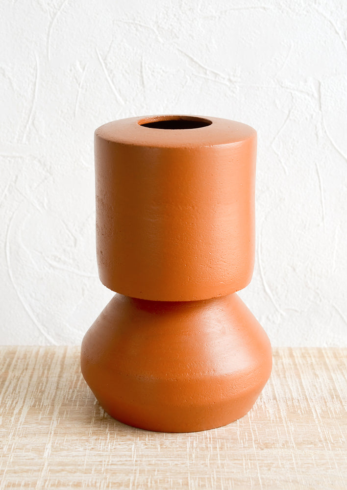 A terracotta vase with shapely silhouette.