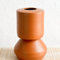 1: A terracotta vase with shapely silhouette.